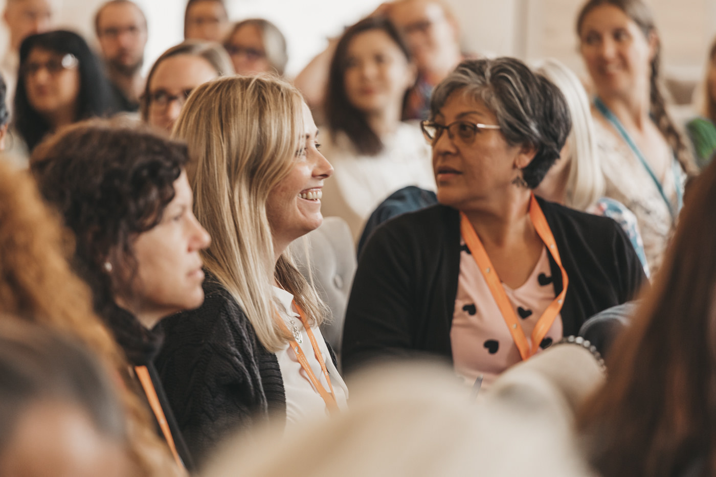 Audience at an RTT event, women smiling and engaged